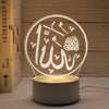 A glowing acrylic night light featuring Arabic calligraphy designs on a circular background.