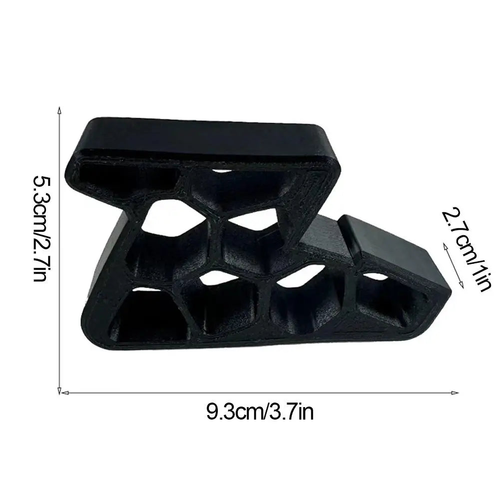 Black heavy-duty non-slip door stopper wedge with a textured, multi-faceted design.