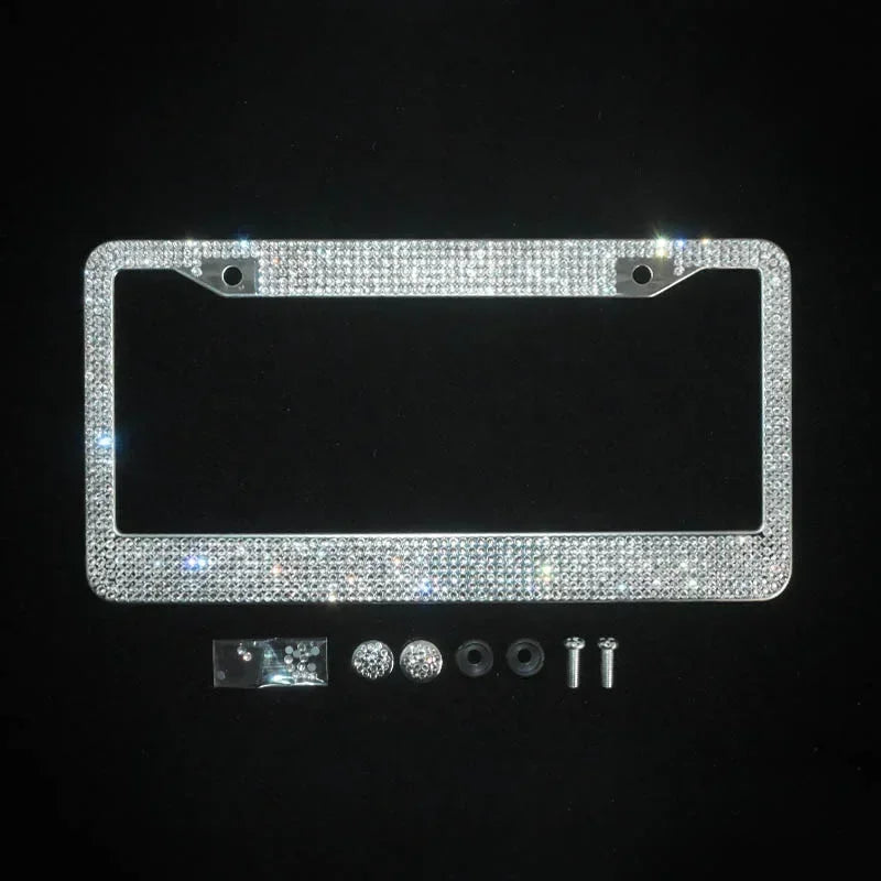 A rectangular crystal rhinestone license plate frame with two screw caps and various mounting hardware components.