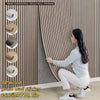 A woman is applying 3D wood grain wall stickers onto a vertical panel, demonstrating the texture and installation of the peel