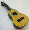 A yellow acoustic guitar-shaped toy ukulele with a pick and tuning pegs.