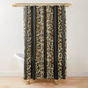 A black and gold leopard print shower curtain hanging from a wooden rod.
