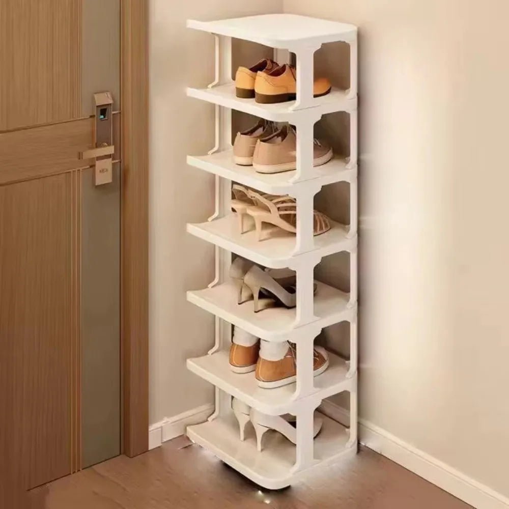 A white stackable vertical shoe rack with multiple tiers holding various pairs of shoes.
