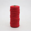 A spool of bright red macrame cord, 3mm/4mm thickness, used for crafting.