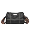 A black vintage genuine leather women's shoulder bag with white stitching and a brown strap.