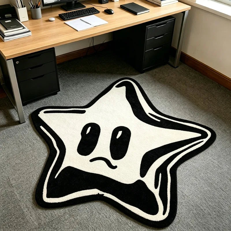 A black and white irregular pentagram rug with a simple, sad face design on a gray floor.