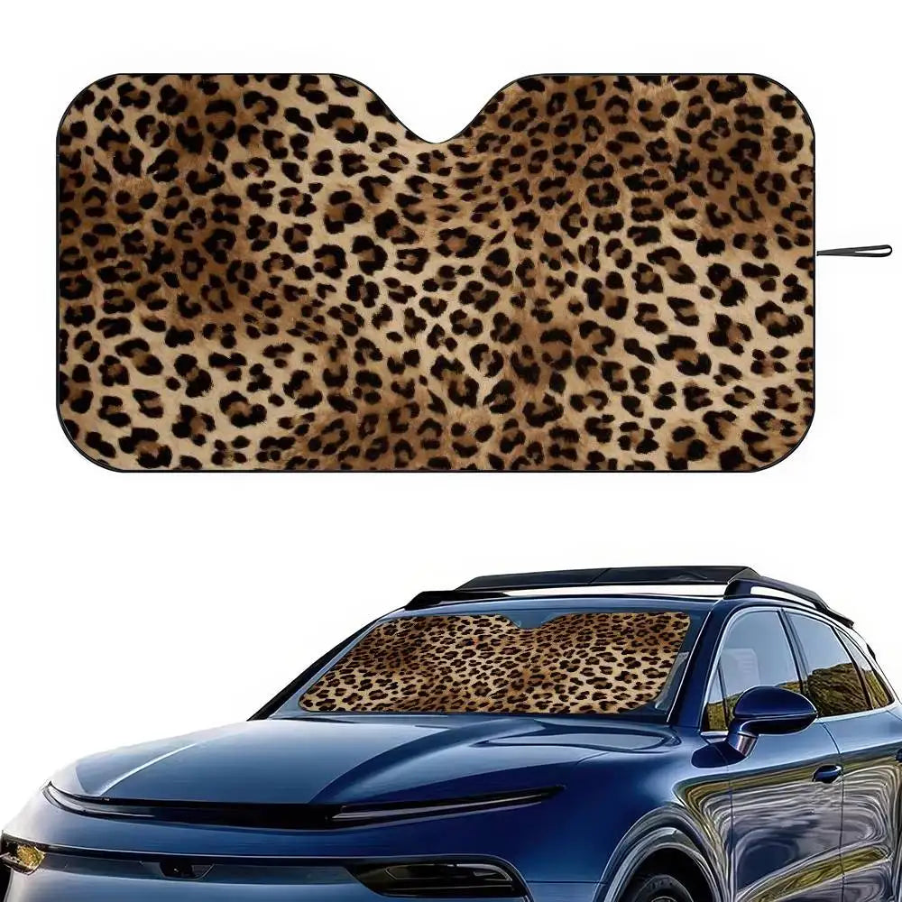 Leopard print car windshield sunshade applied to a blue car window.