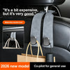 A gray leather seat back hook with a metal alloy double hook is shown hanging in a car interior.