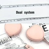 Pink PU leather tape measure shown next to a ruler, demonstrating dual system for body measurements.