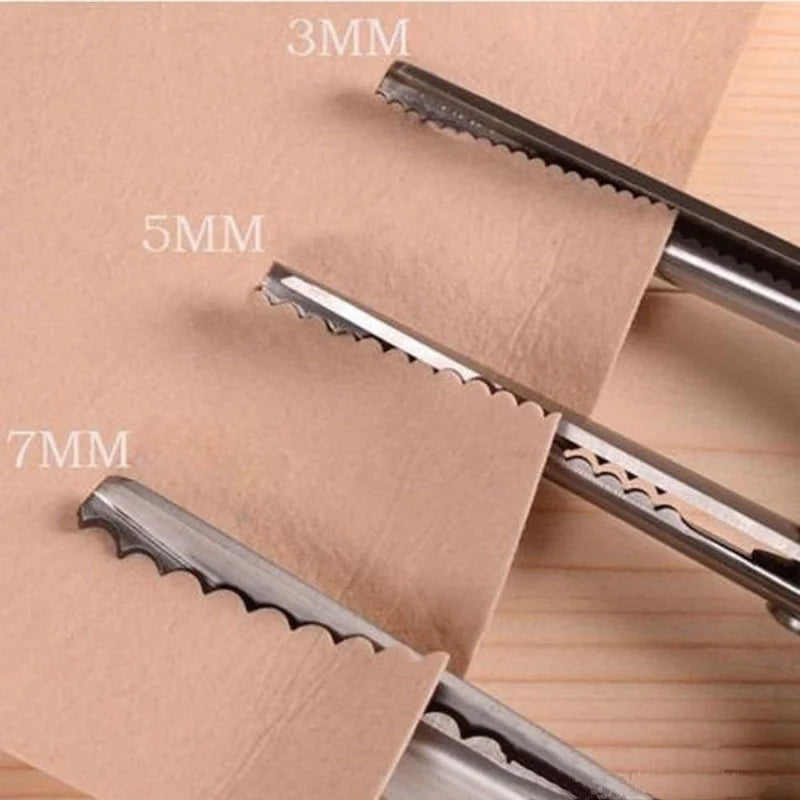 Close-up of professional scalloped lace scissors with various blade sizes marked 3mm, 5mm, and 7mm resting on brown paper.