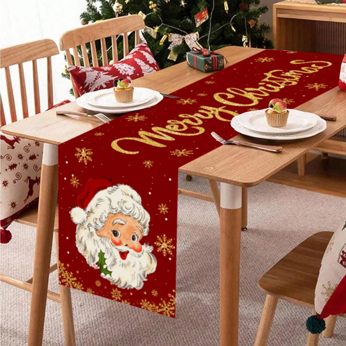 Festive Santa Claus Christmas table runner with red background and gold lettering on a wooden table.