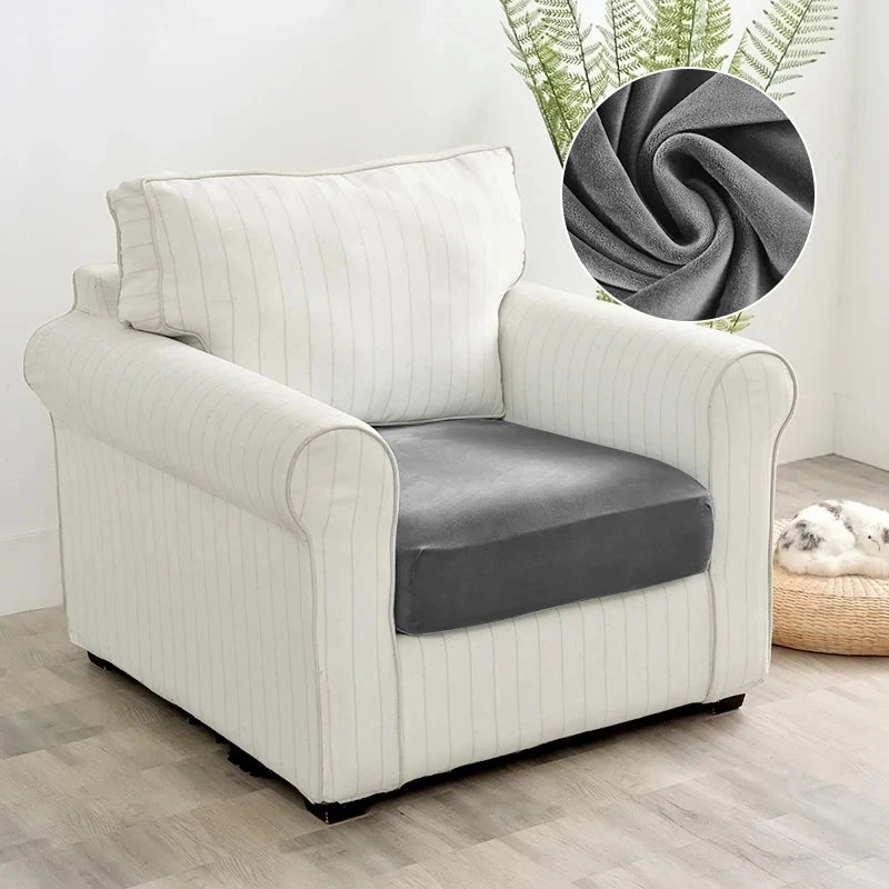 A cream-colored plush velvet stretch sofa seat cover with a gray cushion and vertical stripes.