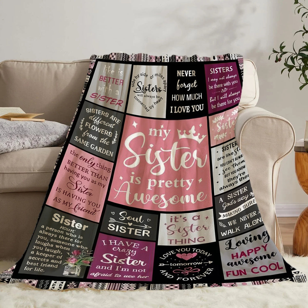 A patterned flannel throw blanket featuring text about sisters and family relationships.