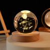 Laser engraved crystal ball night light with a floral design on a wooden base