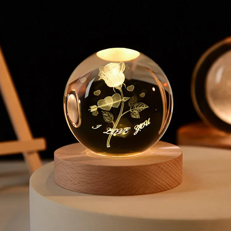 Laser engraved crystal ball night light with a floral design on a wooden base