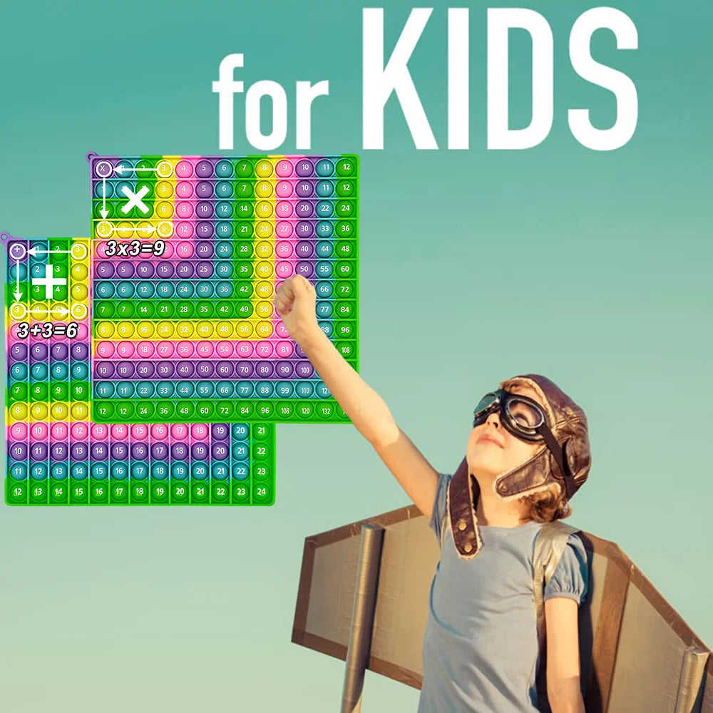 A child is playing with a colorful push bubble math game featuring grids for addition and multiplication learning.