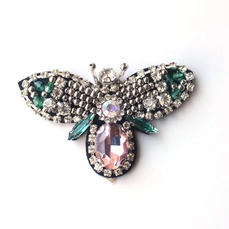 Handcrafted rhinestone bee sew-on patch featuring iridescent pink and green gemstones
