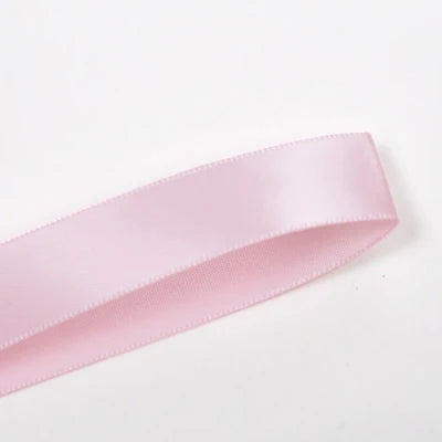 A roll of pink double face satin ribbon.