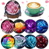A set of sparkling diamond painting coasters and a holder featuring various floral designs in pink, yellow, purple, blue, and