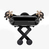 A black crystal flower gravity car phone holder with auto-lock featuring gold accents.