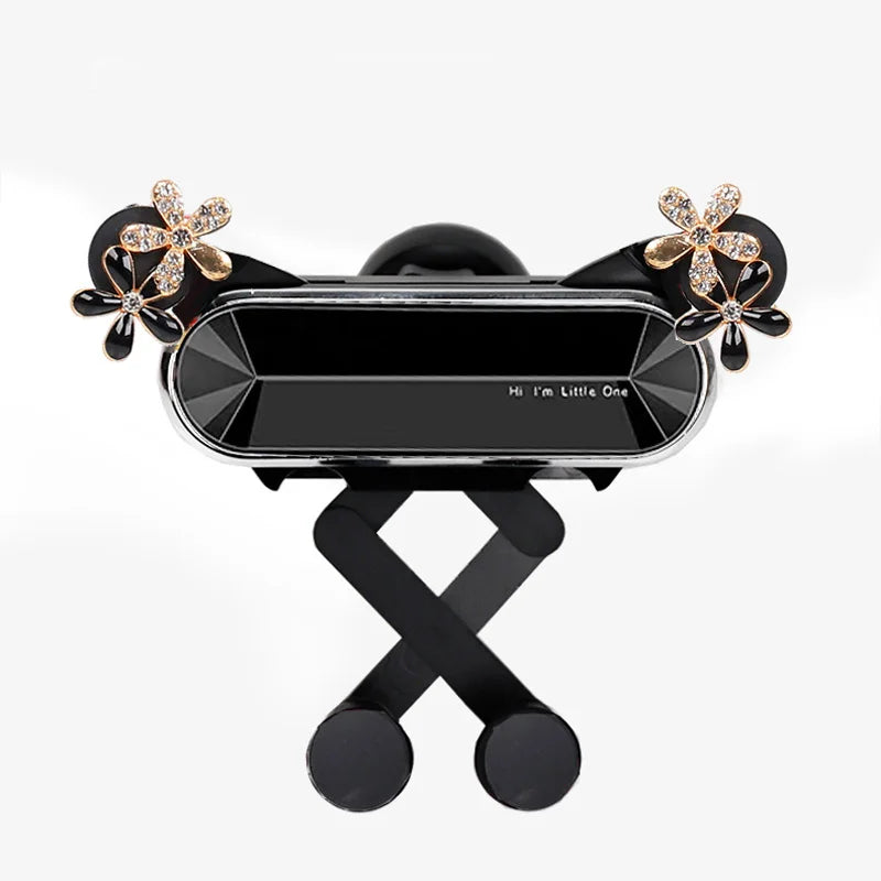 A black crystal flower gravity car phone holder with auto-lock featuring gold accents.