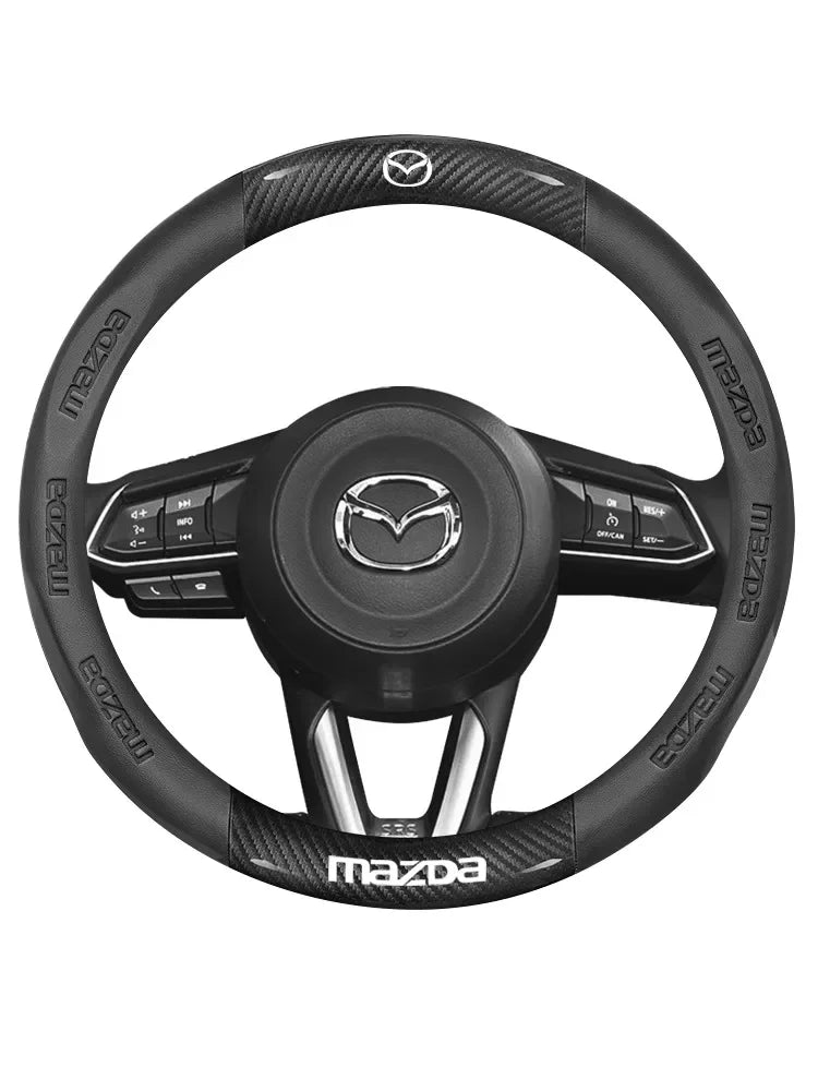 Black carbon fiber and leather steering wheel cover for a Mazda vehicle.