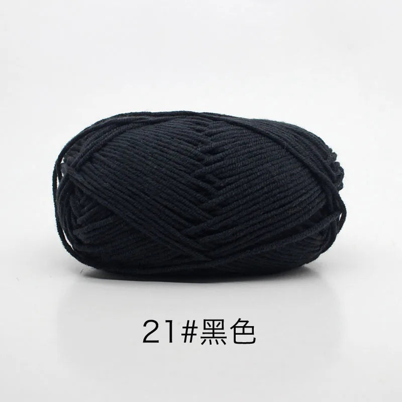 A ball of black 4-ply milk cotton yarn for knitting and crochet.