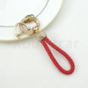 Gold-toned chain key fob cover with clear crystals and a red braided leather strap