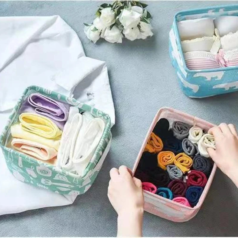 A collection of folded white, purple, and yellow fabric items stored in decorative storage baskets.