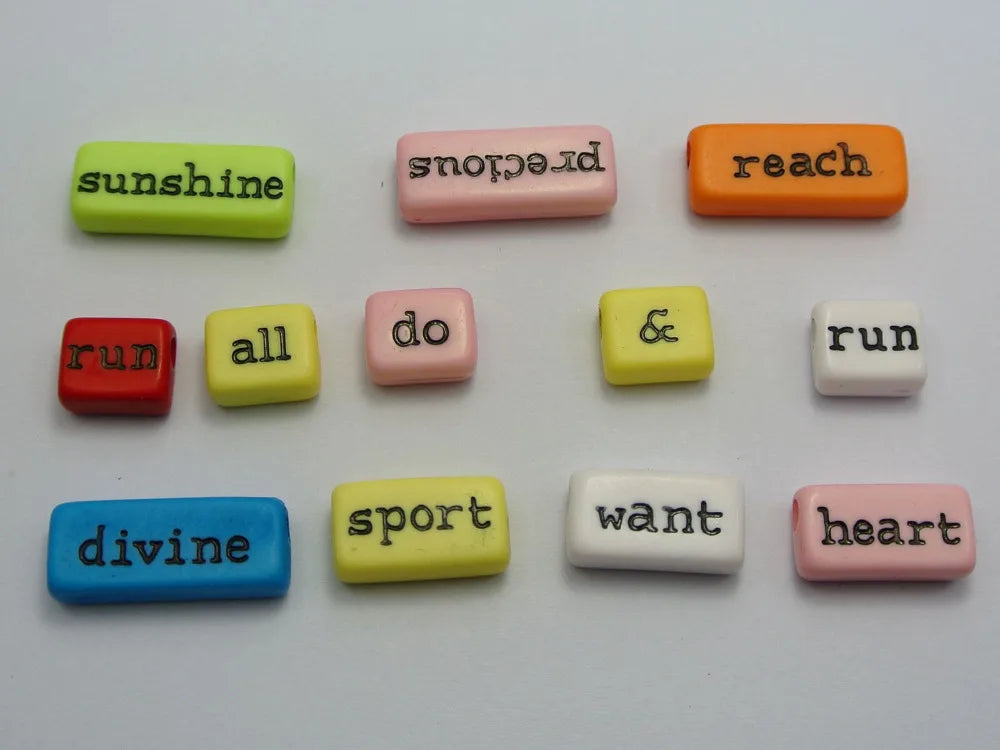 Assorted inspirational word beads in various colors including sunshine, reach, run, all, do, & run, divine, sport, want, and 