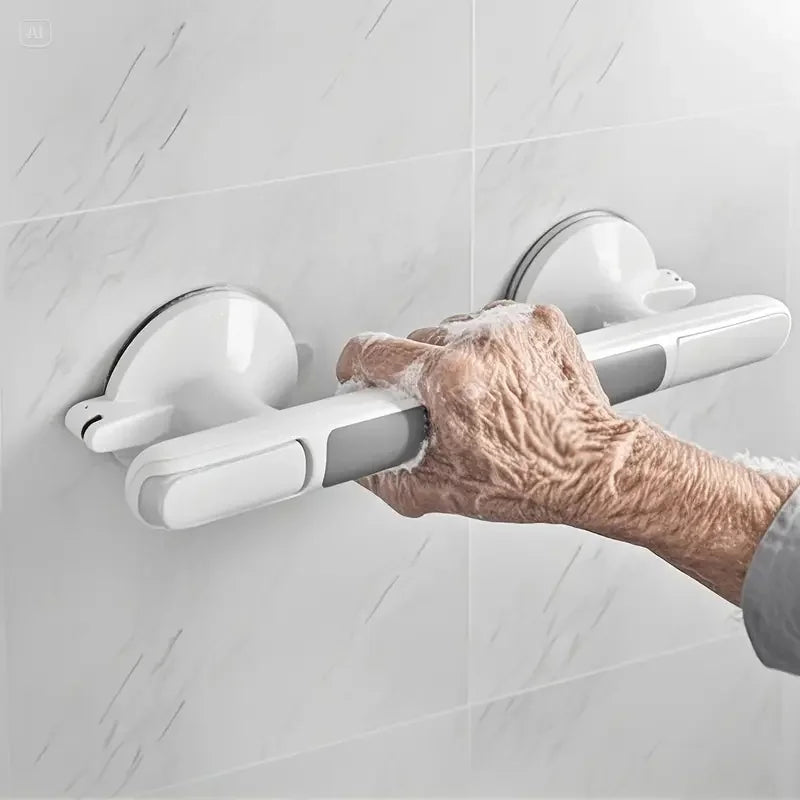 An elderly hand is gripping a white non-slip suction grab bar mounted on a tiled bathroom wall.