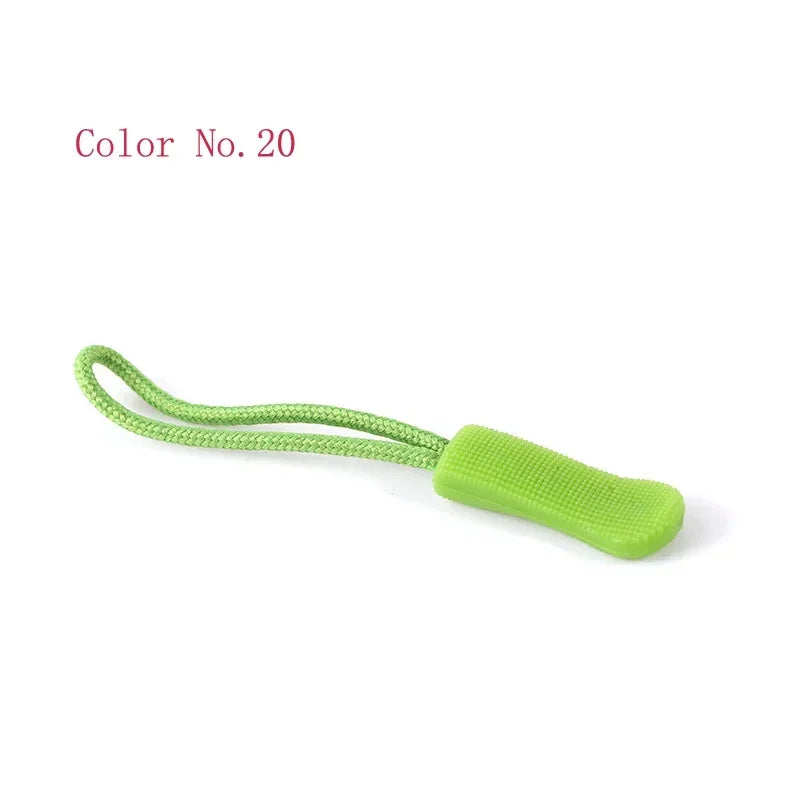 A green plastic zipper pull is shown against a white background.