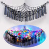 A black bohemian handwoven net with tassels used as a decorative hanging light fixture.