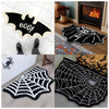Black and white decorative rug featuring a Halloween spider web design with a ghost motif