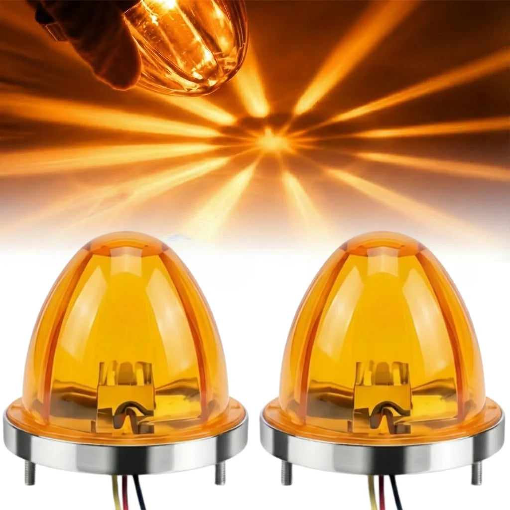 Zwei orange getönte LED-Markierungslichter auf einer Basis, mit hellem Lichtschein im Hintergrund.