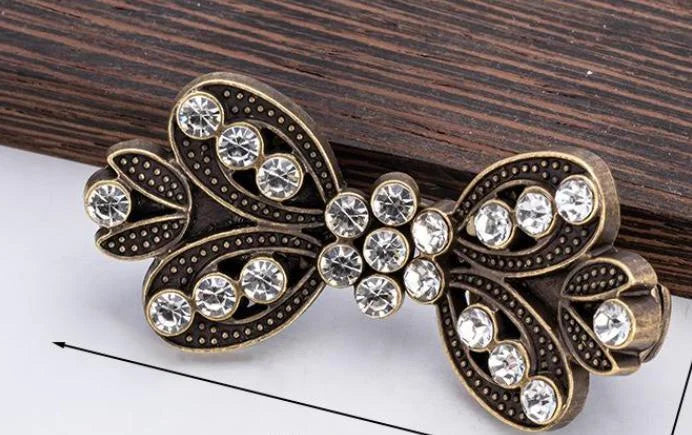 Vintage bronze bowknot clothing clips decorated with clear rhinestones