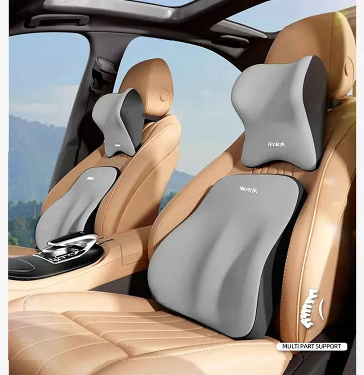 A beige car seat features a gray memory foam headrest and lumbar support cushion for back comfort.