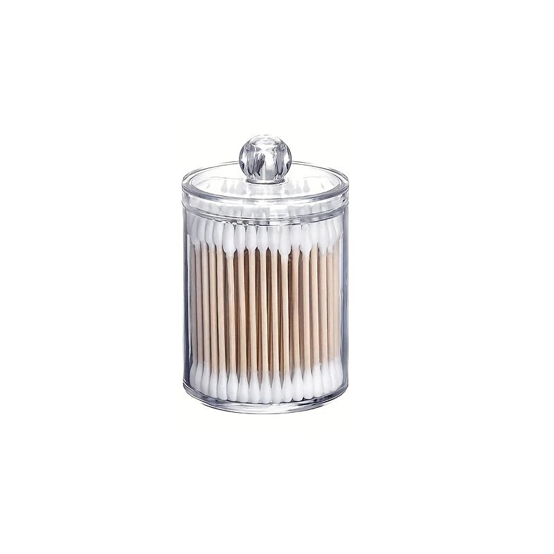 Clear acrylic jar with a lid holding numerous cotton balls or swabs.