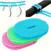 A stack of colorful portable windproof clotheslines in blue, green, and pink.