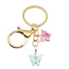 Gold butterfly keychain charm with a pink butterfly detail