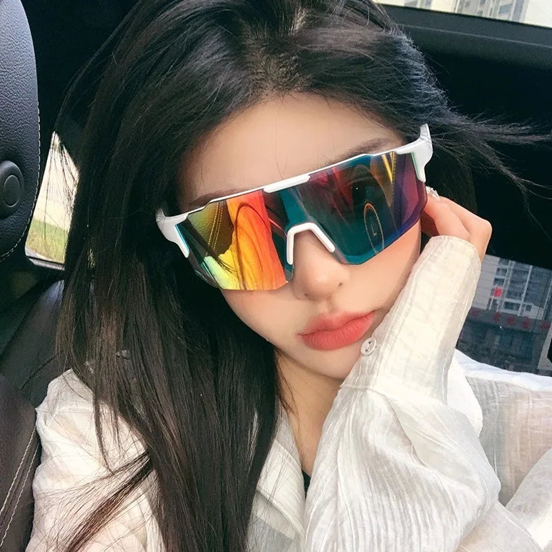 A woman wearing colorful sports sunglasses in a car setting.