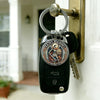 A black key chain featuring a medallion of Saint Michael the Archangel for protection, hanging on a door.
