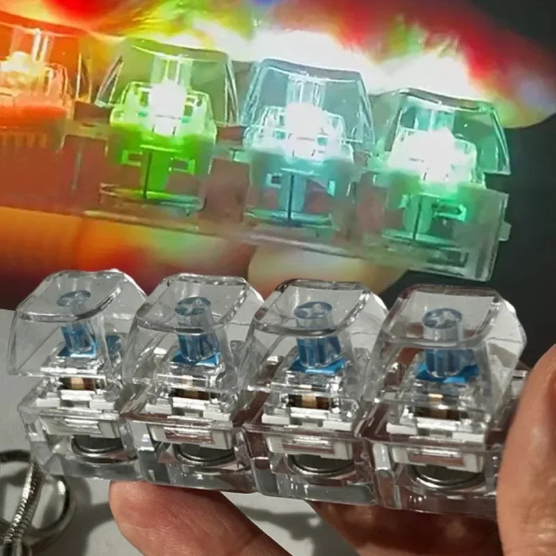A hand holds several clear LED clickable fidget keychains with a keyboard design.