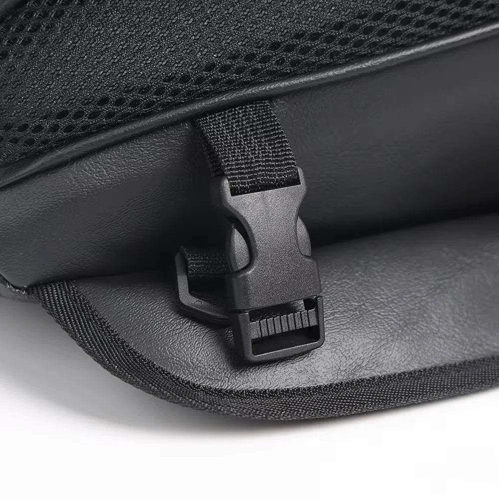 Black motorcycle tail bag with a black strap closure shown in a close-up view.
