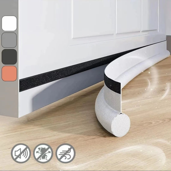 Bande d'étanchéité pour bas de porte autocollante noire et blanche installée sous un meuble blanc, avec des icônes