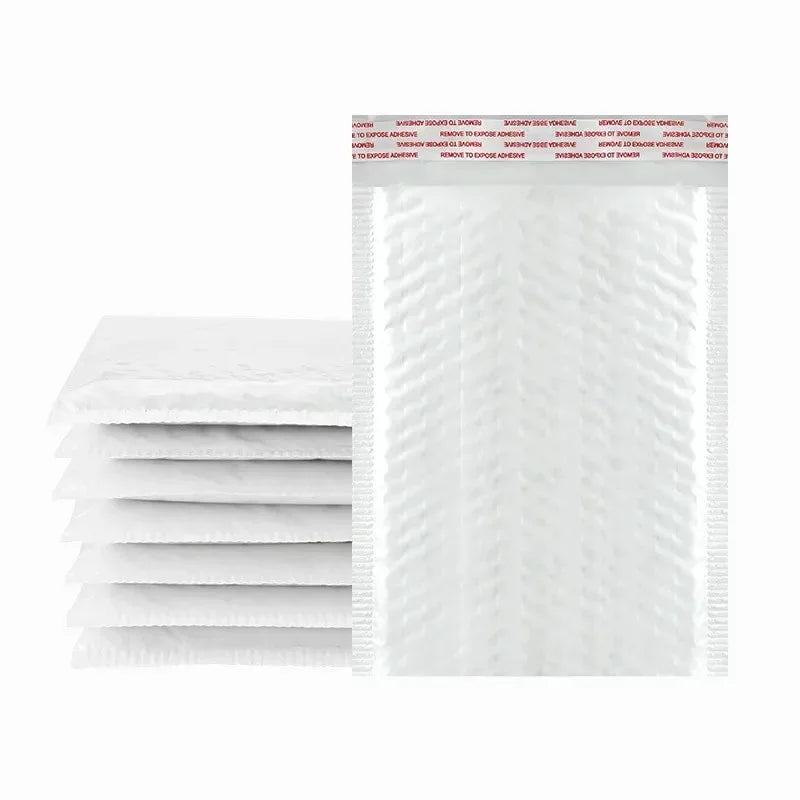 Stack of white padded bubble mailers with self-seal closure