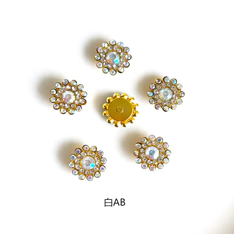 Five decorative flower-shaped rhinestone embellishments in gold and clear stones.