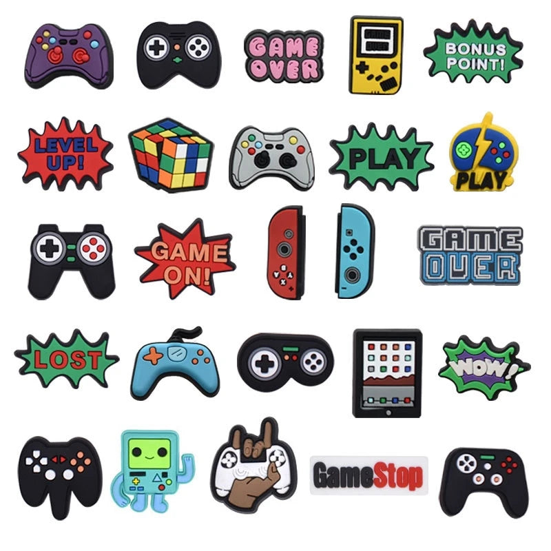 A collection of colorful PVC pins and charms featuring video game themes like Game Over, Play, and Game On.