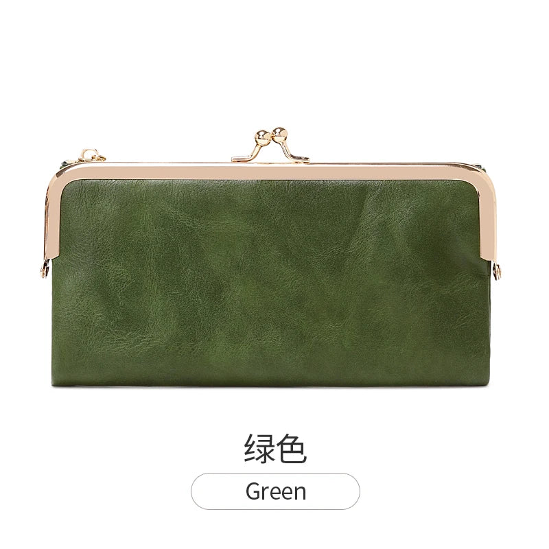 A dark olive green vintage kiss lock long wallet with gold hardware.