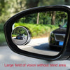 A close-up view of a black car mirror showing a wide field of vision without blind spots.